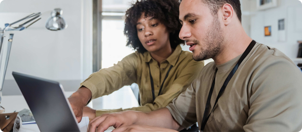 Image of two people looking at a computer