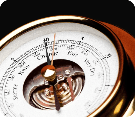 Analog barometer showing atmospheric pressure, with zones labeled 
